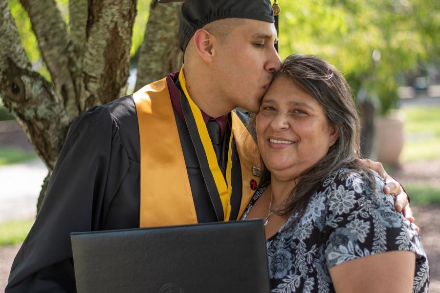 Graduating student embracing parent